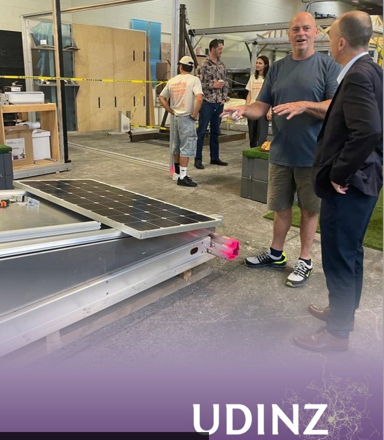 Murphy explaining solar roof integration at UDINZ site tour